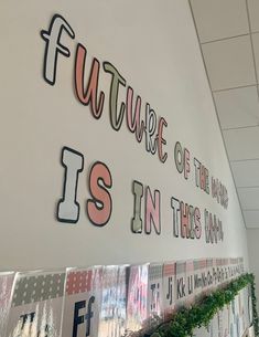 the wall is decorated with letters and plants