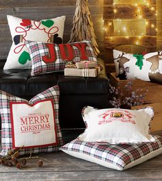 christmas pillows and other holiday decorations on a couch