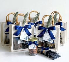 three bags with blue ribbons and tags on them