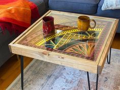 a coffee table with two cups on it