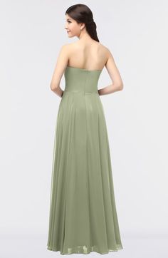 a woman in a strapless green bridesmaid dress looking back at the camera