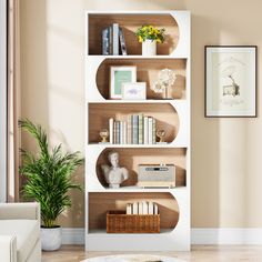 a living room with a white book shelf filled with books and other items on top of it