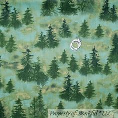 a green background with trees and a ring on it