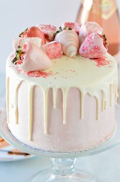 a cake with white icing and strawberries on top