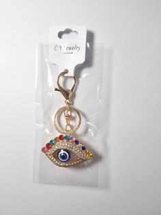 a keychain with an evil eye on it's front and back side