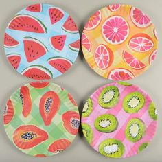 four paper plates with fruit designs on them