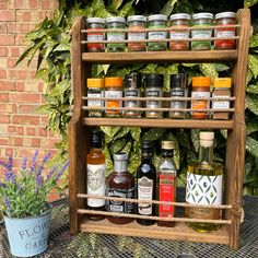 an old wooden spice rack is filled with spices and condiments on a patio