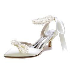 a pair of white shoes with pearls on the heel