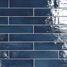 a close up shot of a dark blue tile wall that is being used as a background