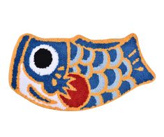 a blue and yellow fish shaped door mat