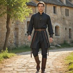 Introducing our sleek Black Medieval Shirt for those in love with historical regalia and superior craftsmanship. This classic design shirt has a loose fit, high collar, and buttoned front to complement Renaissance fairs, historical reenactments, or any other special events looking for a touch of unique taste in attire. With passion, every T-shirt is manufactured under the watchful eyes of skilled workers to ensure we deliver only quality products to our buyers. The soft, long-lasting material an French 1700s Fashion Men, Medieval Mens Fashion, Medieval Groom Attire, Peasant Clothes Male, Celestial Outfit Male, Male Witch Aesthetic Fashion, Midevil Outfits Man, Knight Outfit Men, Medieval Fashion Men