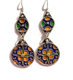 this is a beautiful pair of vintage style silver Berber enamelled earring from Morocco.  It is all handmade by the best Berber silver smith in Morocco.  The silver is over 90% Size: 2.7 inch long and one inch wide Nickel Free Enamel Dangle Earrings, Artisan Silver Earrings With Artistic Design, Silver Artisan Earrings With Artistic Design, Vintage Pierced Enamel Jewelry, Traditional Hand Painted Drop Earrings, Traditional Hand Painted Dangle Jewelry, Green Enamel Earrings With Artistic Design, Vintage Pierced Enamel Earrings, Vintage Multicolor Enamel Earrings