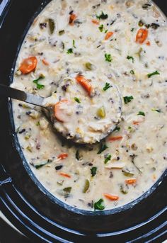 a ladle full of soup in a crock pot