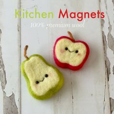 two apples with faces made out of felt