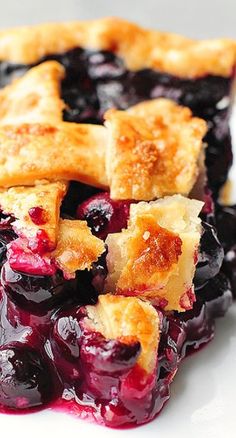 a white plate topped with blueberry cobbler pie