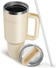 a white coffee cup with a straw and lid next to a tumbler mug that has the lid open