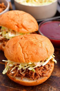 two pulled pork sandwiches with coleslaw and ketchup