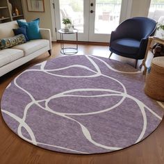 a living room filled with furniture and a purple rug on top of a hard wood floor