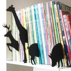 bookshelf with several silhouettes of animals on it