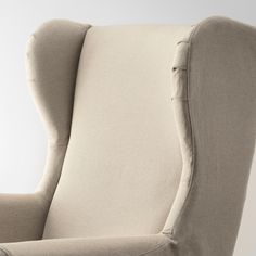 an upholstered wingback chair is shown in this image