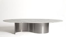 a white marble table sitting on top of a metal base