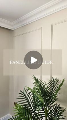 a potted plant sitting on top of a wooden table next to a white wall