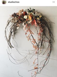 an image of a wreath made out of twigs and flowers on the wall with instagrams