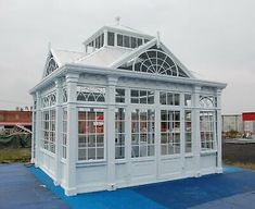 a large white building sitting on top of a blue platform