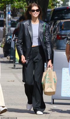 a woman walking down the street carrying shopping bags