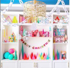 a room filled with lots of colorful decorations and bookshelves on top of white shelves