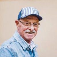 an older man wearing a hat and glasses