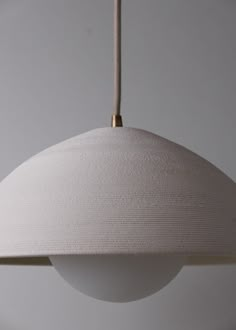 a white light hanging from a ceiling fixture