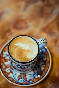 a cappuccino on a saucer with a spoon