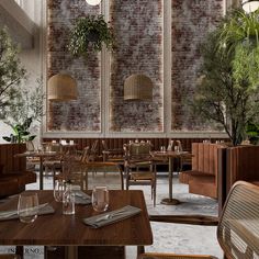 an empty restaurant with wooden tables and wicker chairs in front of brick wall panels