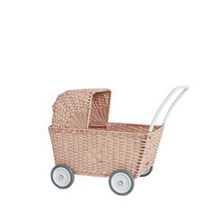 a pink wicker stroller with white wheels