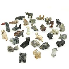 a collection of small animal figurines on a white surface