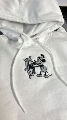 One (1) Steamboat Willie Hoodie or Sweatshirt Sweatshirt: Hanes 50/50 cotton/poly Hoodie: Jerzees 50/50 cotton/poly NuBlend® pill-resistant fleece Follow our care instructions: Wash in cold water with similar colors, avoid bleach, tumble dry on low, and iron on low heat if necessary. Do not dry clean. White Cotton Hoodie With Embroidered Logo, White Embroidered Hoodie For Streetwear, White Crew Hoodie With Embroidered Graphics, White Fleece Crew Hoodie, White Hoodie With Embroidered Graphics, White Embroidered Crew Hoodie, White Cotton Crew Hoodie, White Embroidered Crew Neck Hoodie, White Hoodie With Custom Embroidery For Winter