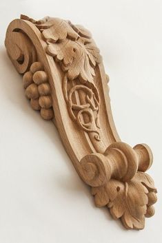 a carved wooden object on a white surface