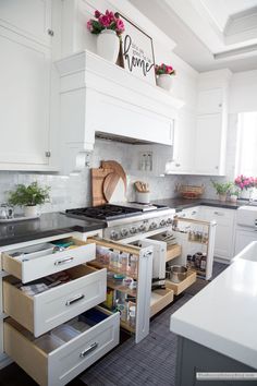 an open drawer in the middle of a kitchen