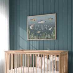 a baby's crib in front of a blue wall with fish on it