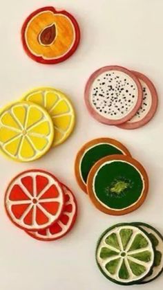 four slices of fruit are arranged on a white surface