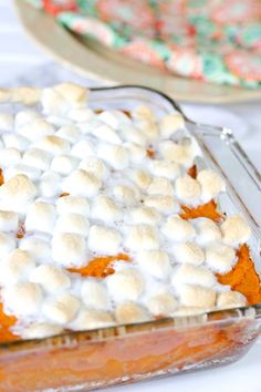 a casserole dish with marshmallows and orange sauce in it on a table