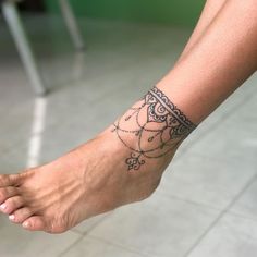 a person's foot with a tattoo on the top of it and an ankle