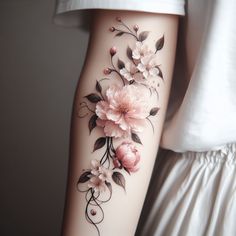 a woman's arm with flowers painted on it