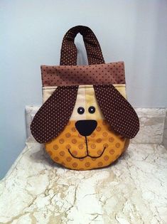 a purse with a dog's head on it is sitting on a counter top