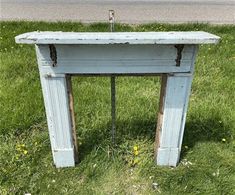 an old blue table sitting in the grass