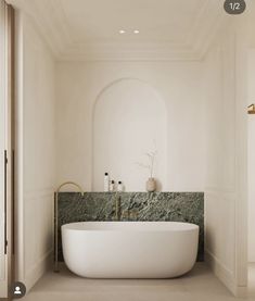 a large white bath tub sitting in a bathroom