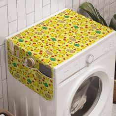 a washer and dryer sitting next to each other in front of a tiled wall