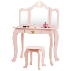 a pink vanity table with mirror and stool