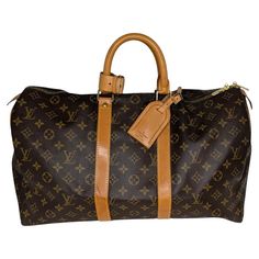 From the 1995 Collection; Louis Vuitton Weekender Bag in brown coated canvas with the iconic LV logo monogram and brass hardware. It features dual rolled handles, canvas lining and a zip closure at top. Comes with an Entrupy Certificate for peace of mind. Est. Retail $2,200. Designer: Louis Vuitton Material: Monogram canvas; cowhide leather Date/Authenticity Code: SD0975 Production Year: July 1995 in the U.S.A. Measurements: 17.7"W x 10.6"H x 7.9"D Drop: 4" Closure/Opening: 2-way zip Interior Lining: Canvas Hardware: Gold-tone Brass Includes: Leather ID tag, Handle keeper and Entrupy COA Condition: Very Good Pre-Loved Vintage Condition; exterior canvas is all intact w/ faint white markings, hardware is bright and shiny with minor tarnishing to the grommets, minimal darkening to piping, zip Lv Keepall 45, Louis Vuitton Weekender, Louis Vuitton Keepall 45, Vintage Designer Bags, Keepall 45, Lv Logo, Wish Board, Hermes Kelly Bag, Cartier Panthere